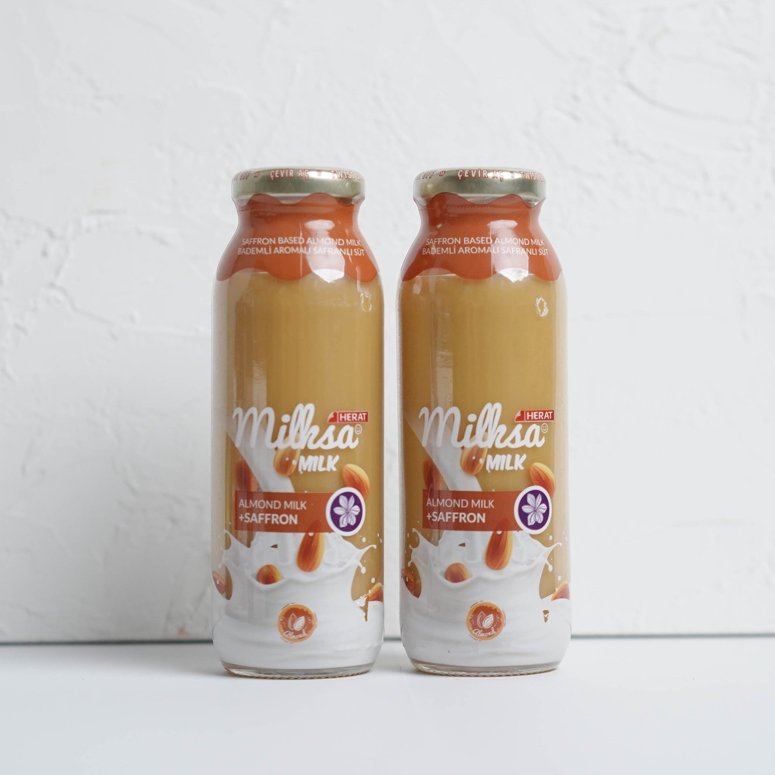 Two bottles of Millesimé milk on a white background