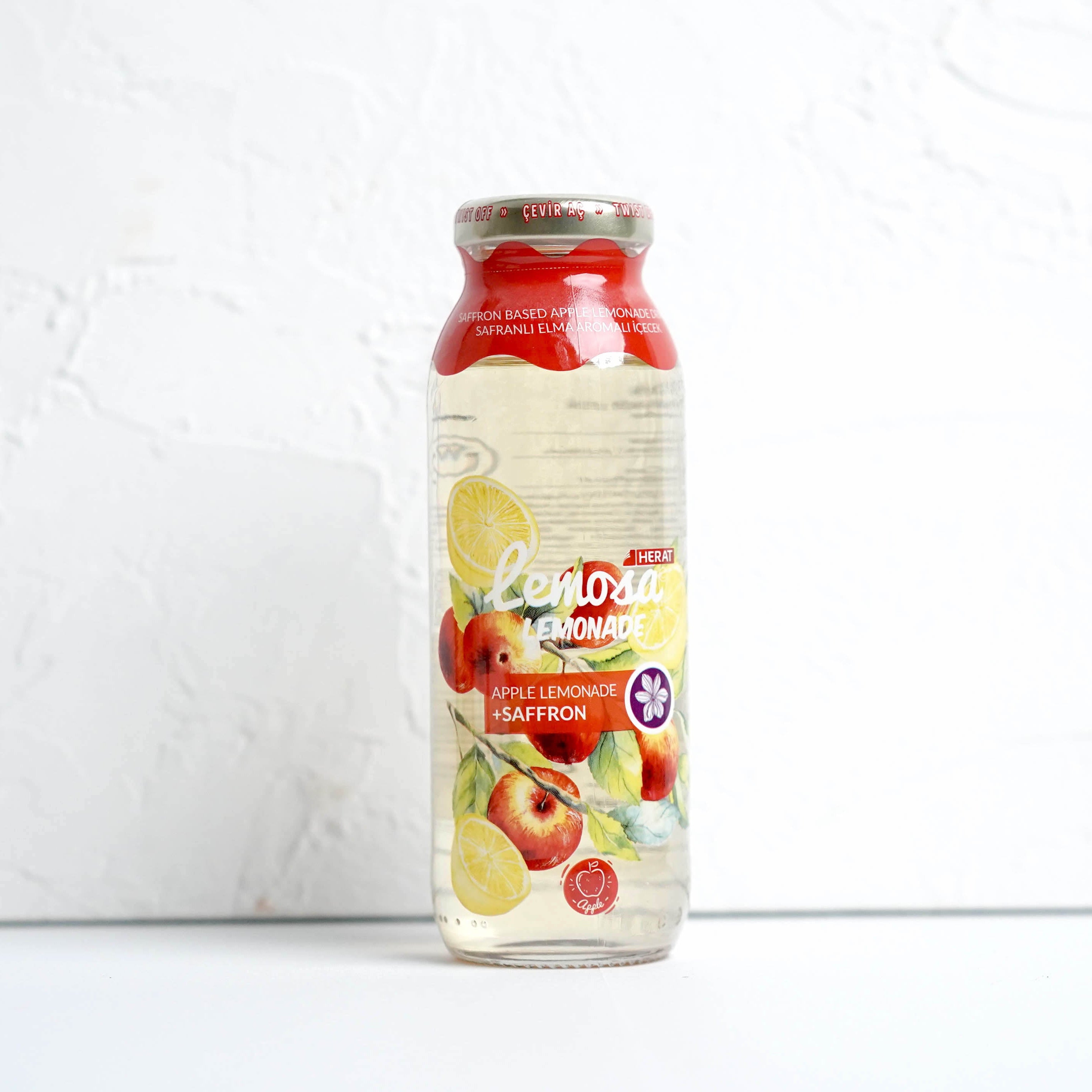 Bottle of Fage yogurt with apple pieces on a white background