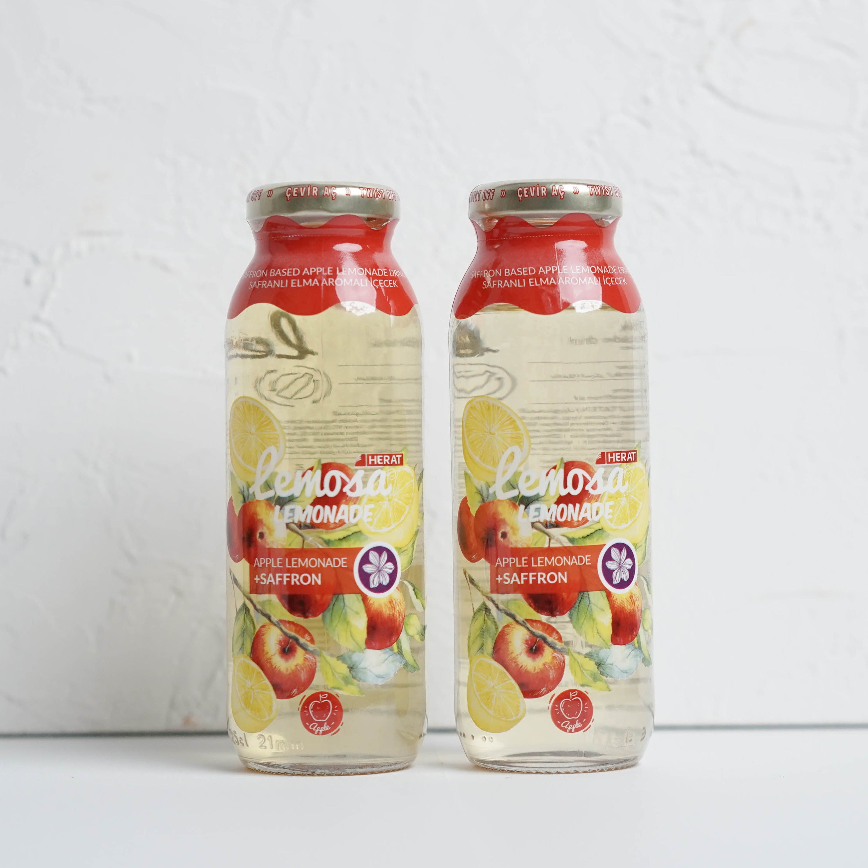 Two bottles of Apple & Eve juice on a white background