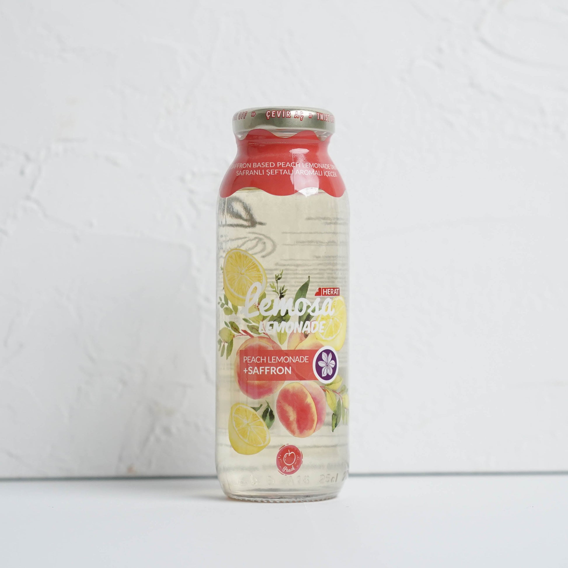 Bottle of lemon peach saffron on a white background