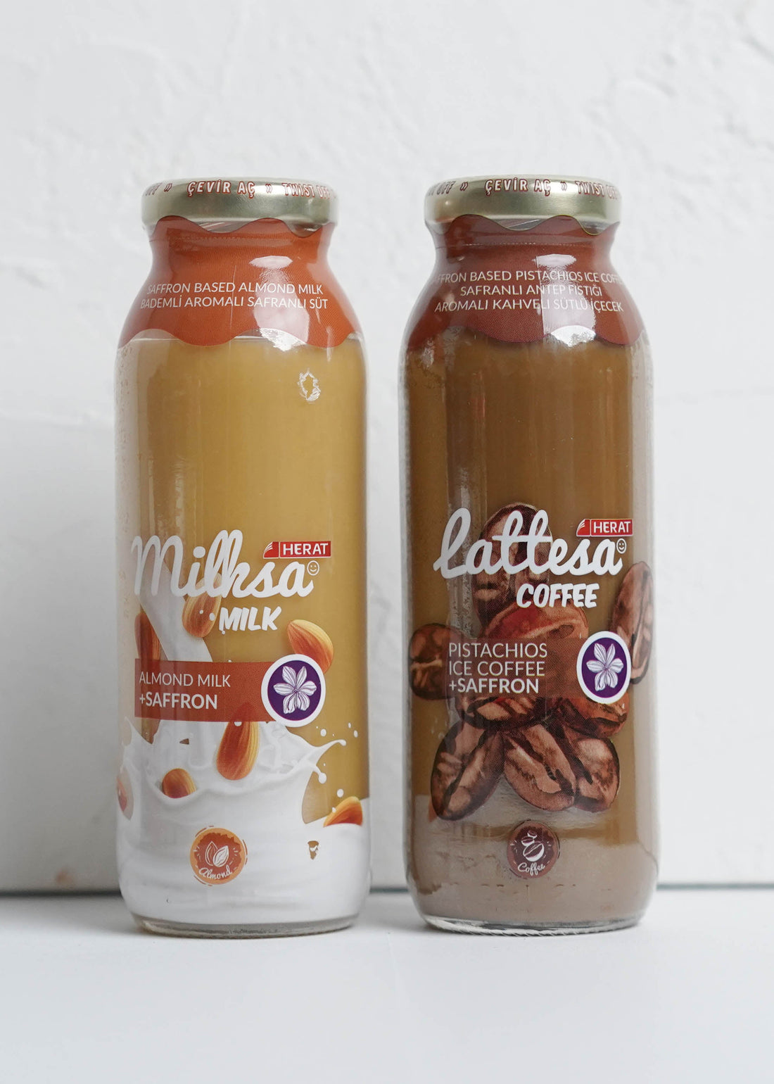 Two bottles of milk and coffee on a white background