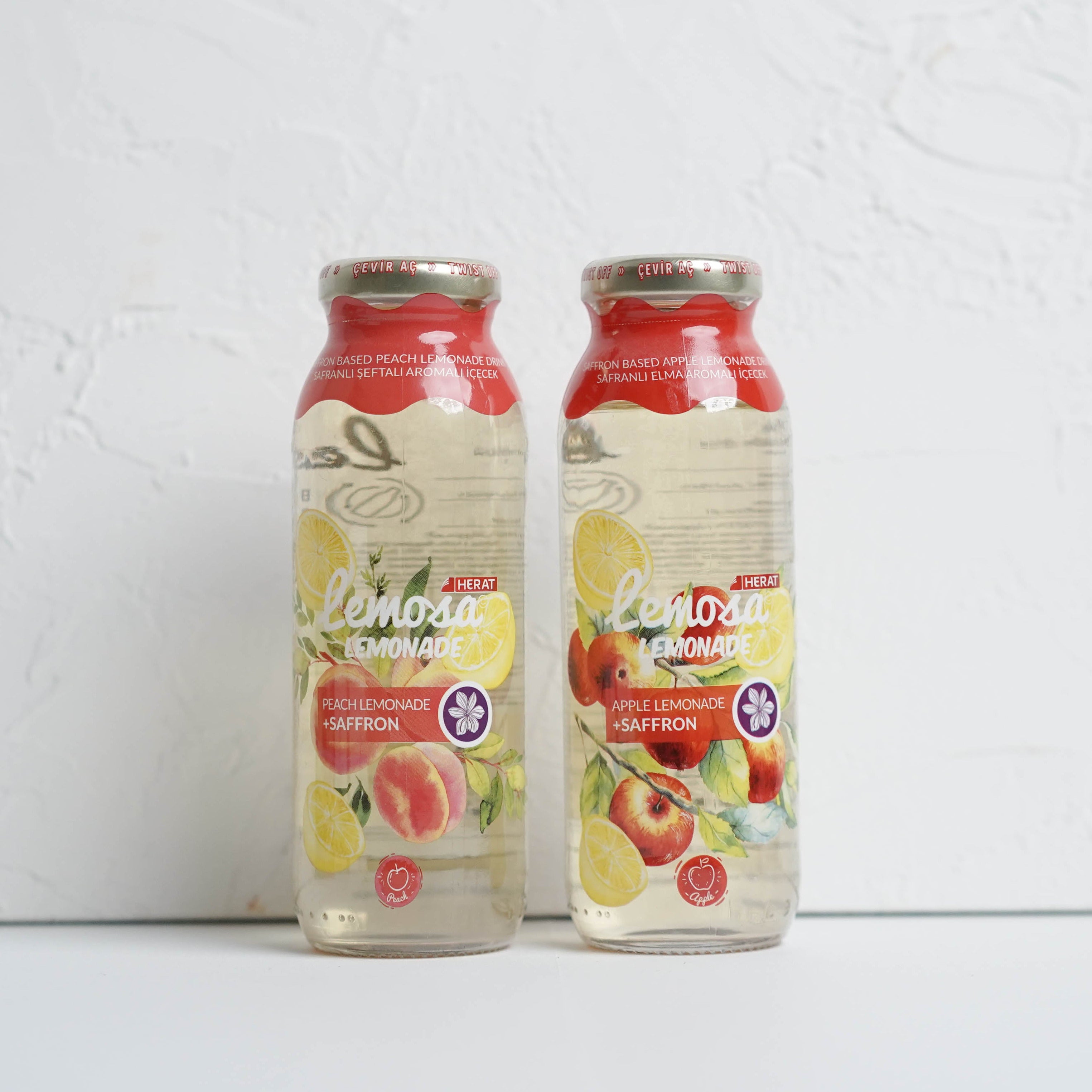 Two bottles of Lactose Free Apple Juice on a white background