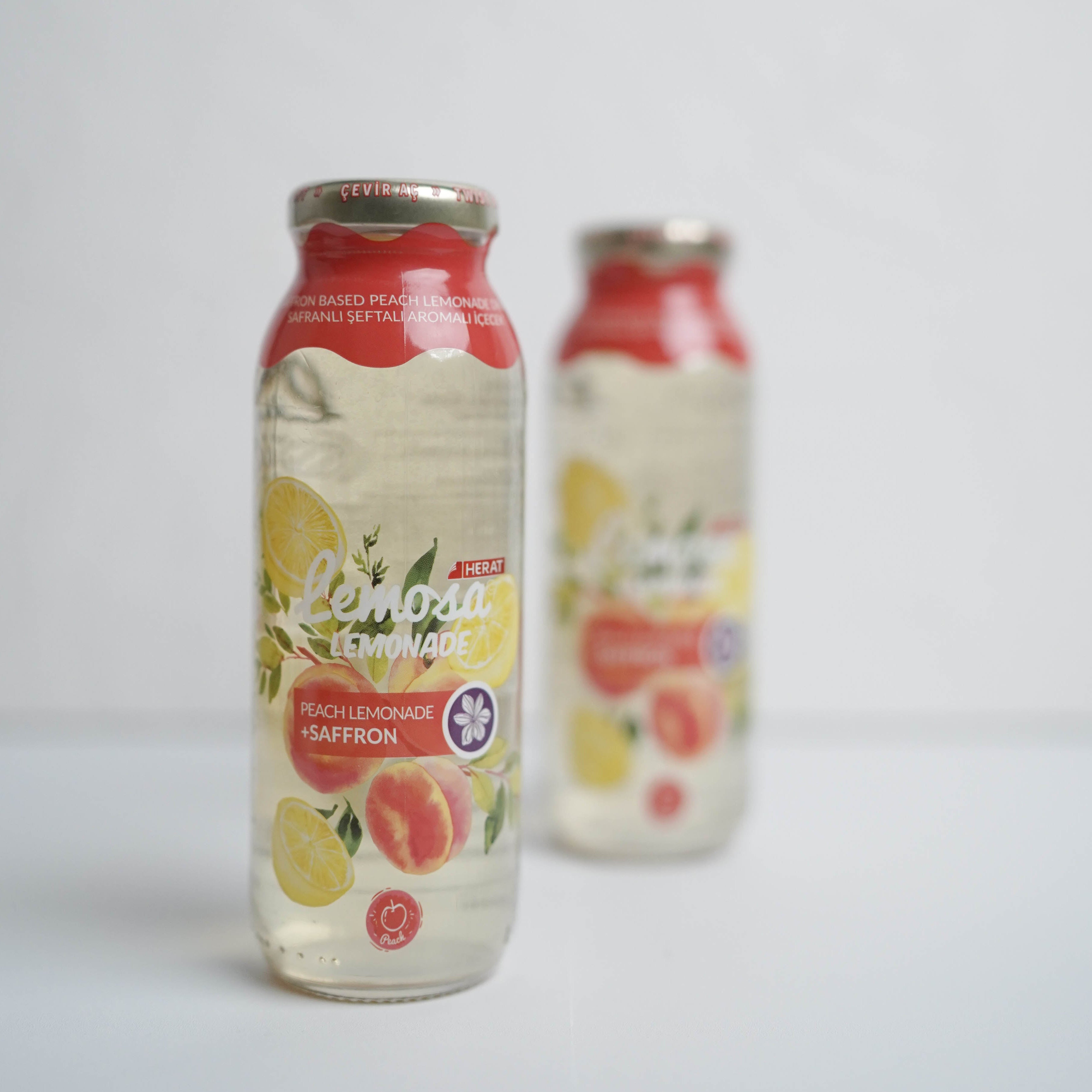 Two bottles of Lemonade & Co. lemonade on a light gray background
