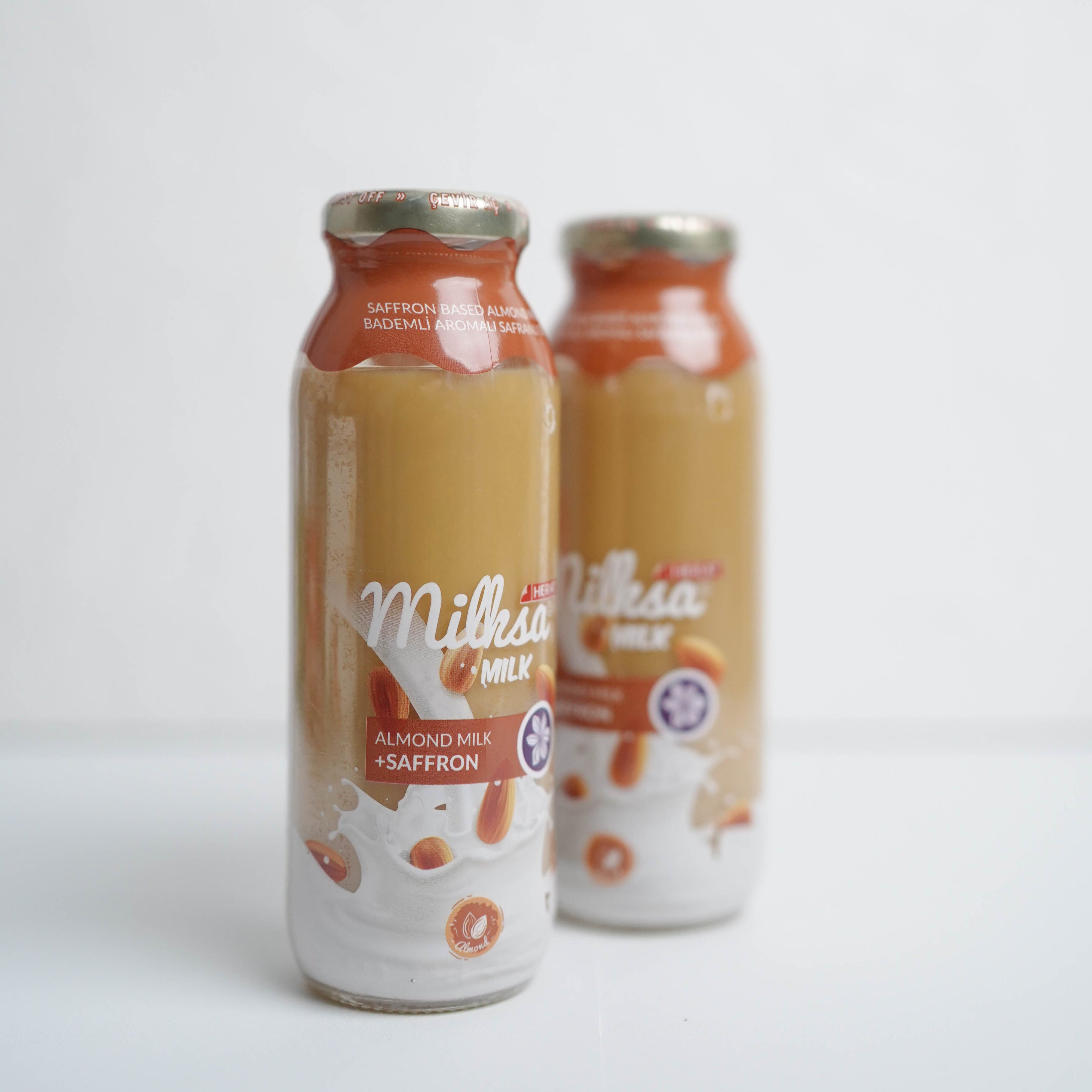 Two bottles of Millesimé Saffron on a white background