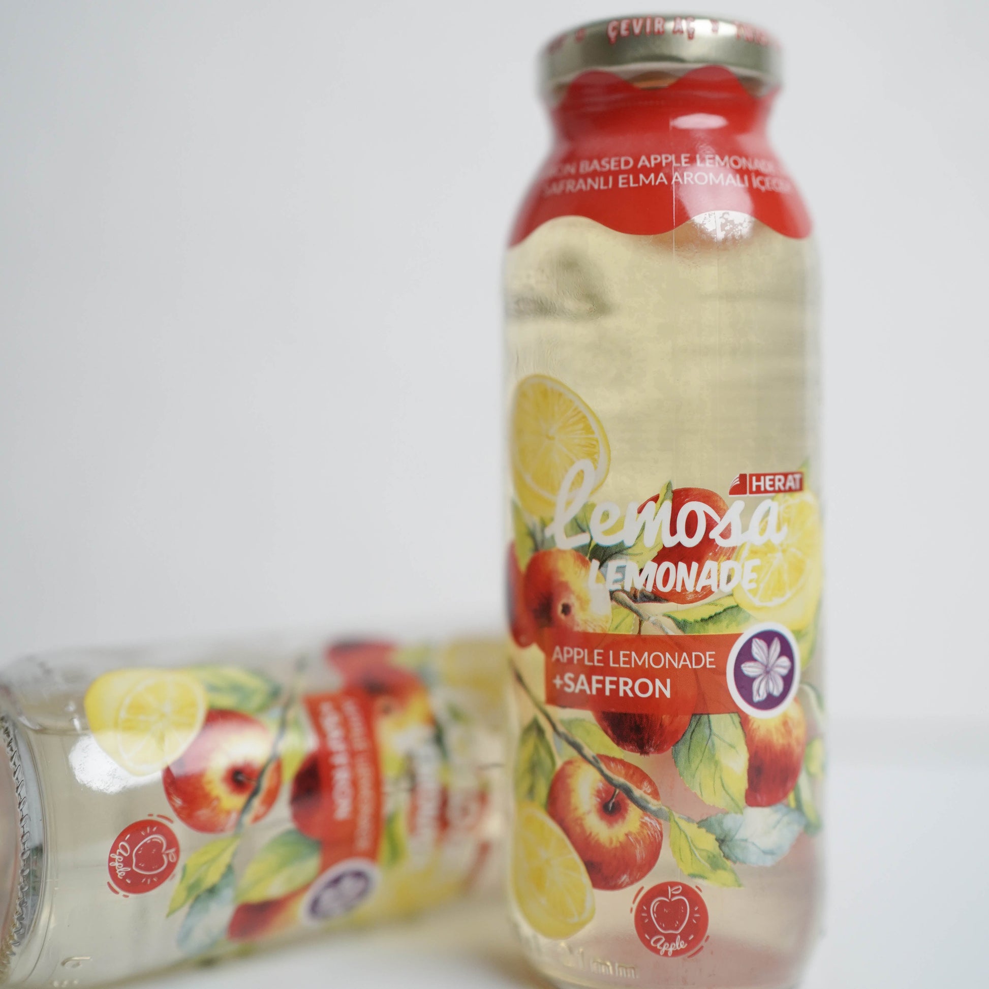 Bottle of lemonade with fruit illustration on a white background