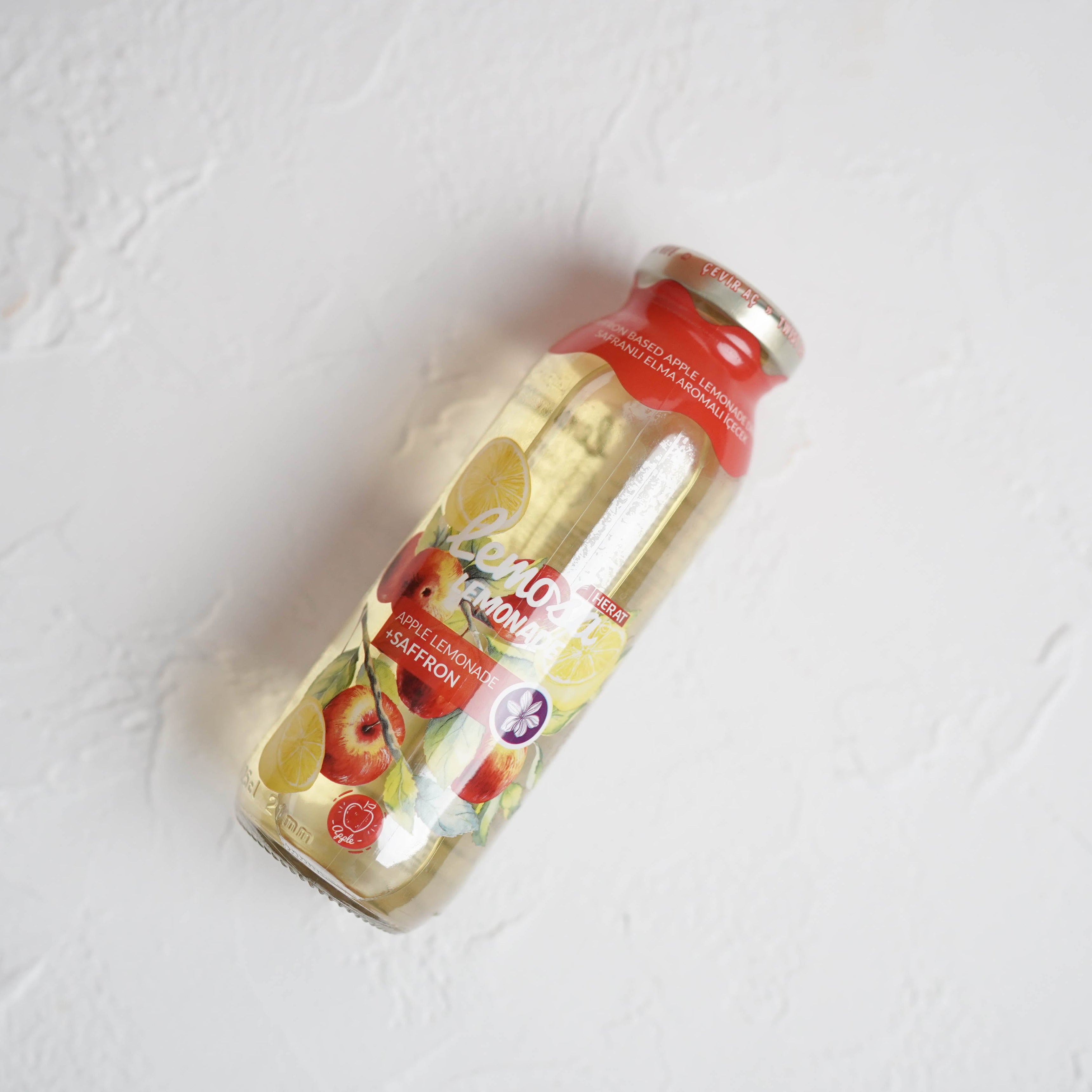 Bottle with a red cap on a light gray background