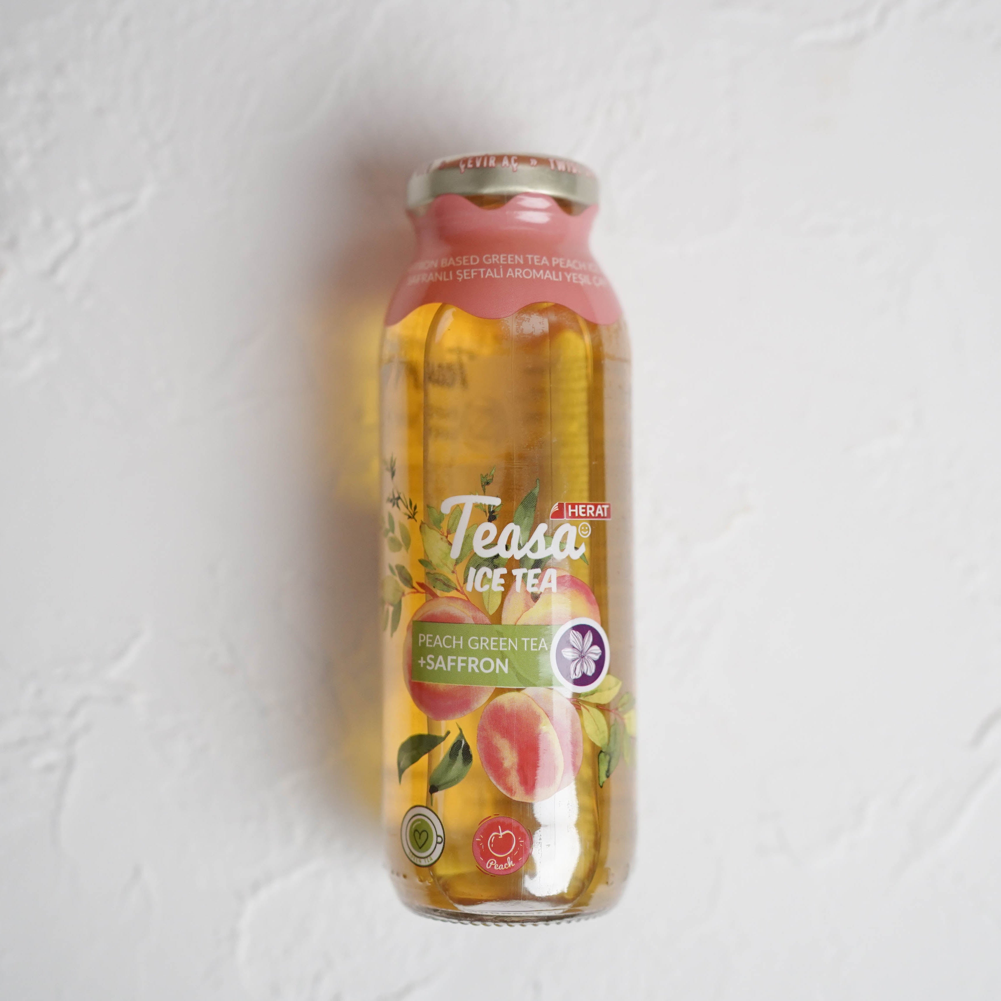 Bottle of Teasa fruit tea on a light gray background