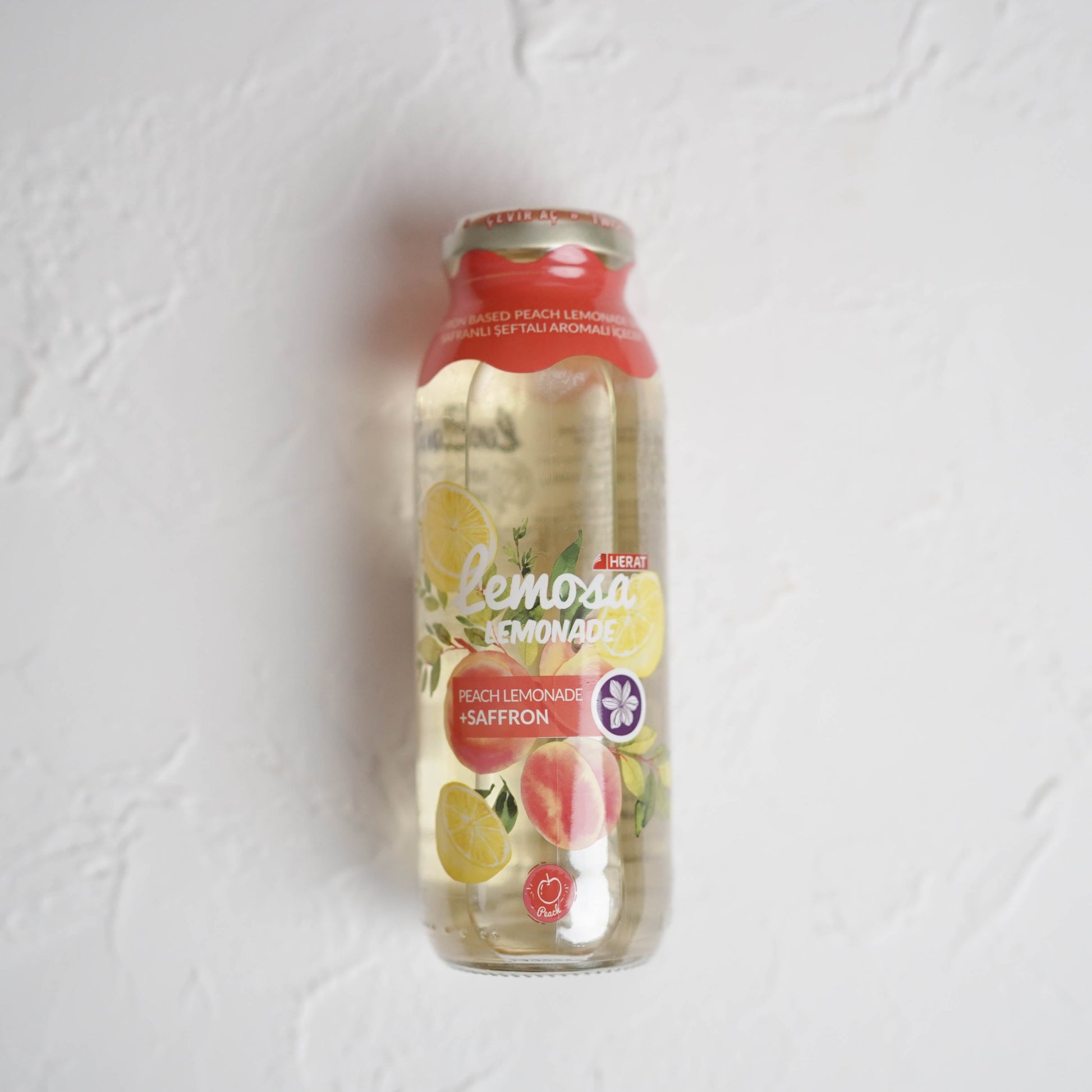 Bottle of lemonade on a textured white background