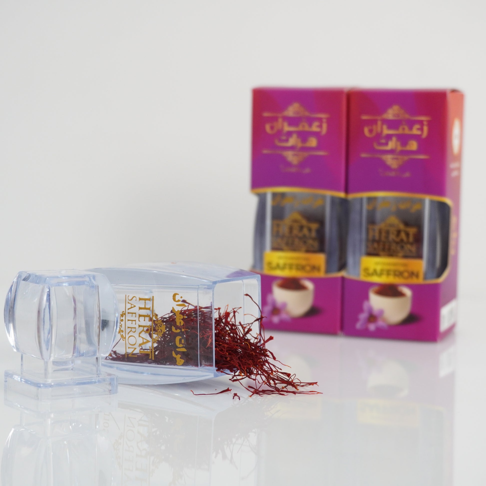 Saffron threads with saffron boxes on a white background