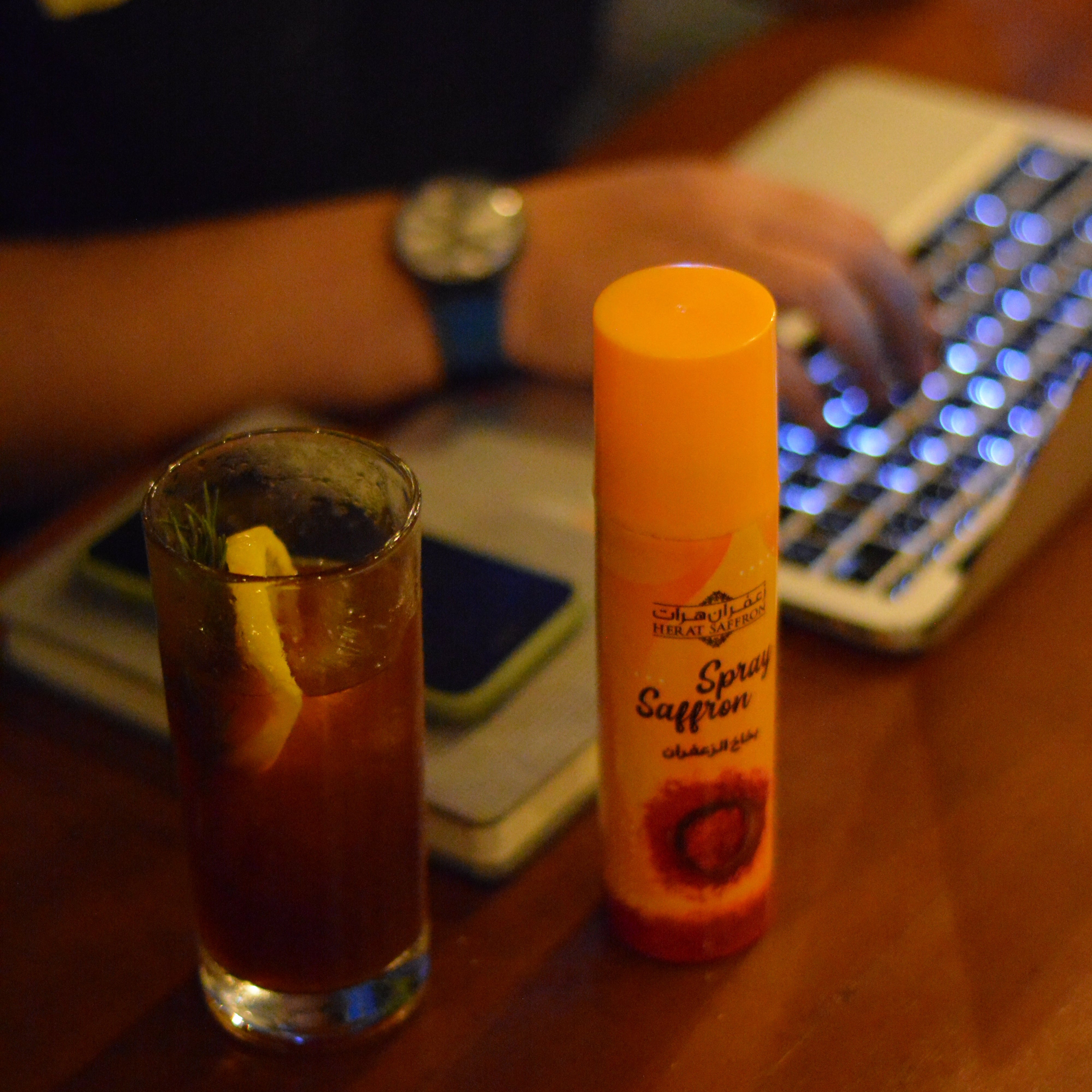 Two lip balms held by a person with a blurred background